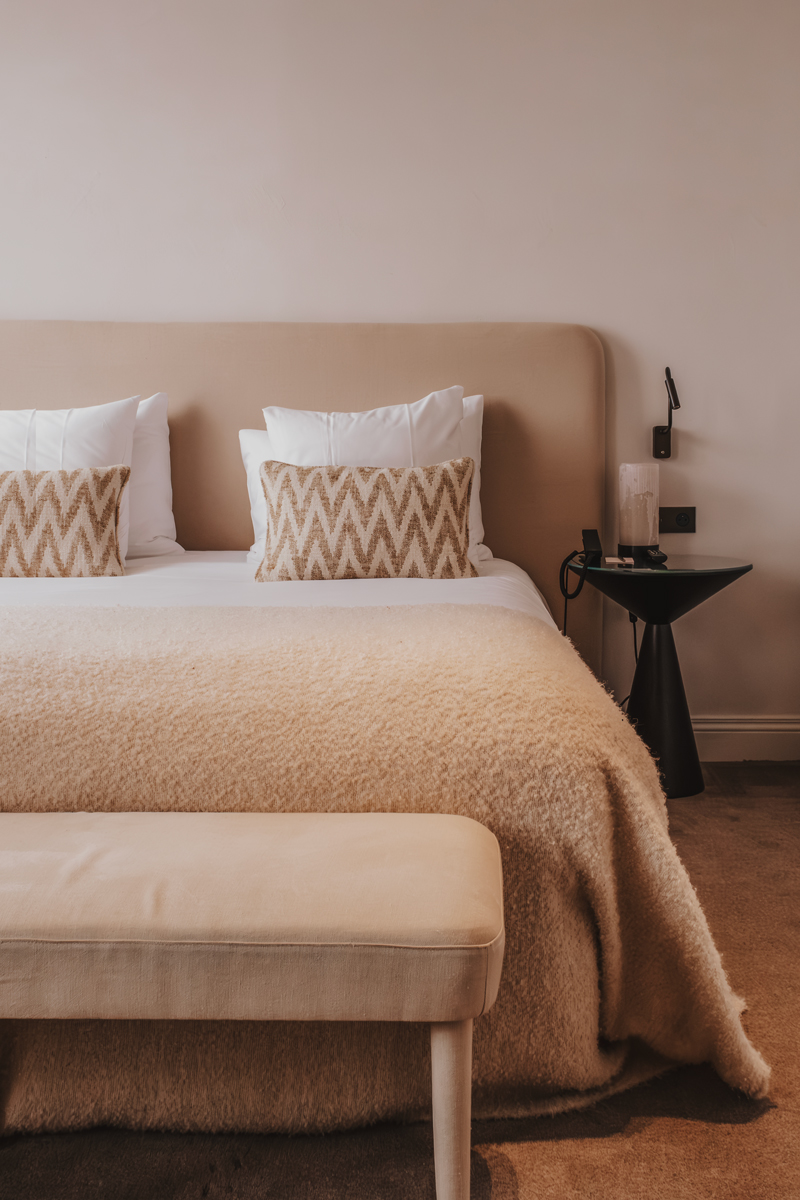 Neutral bedroom with chevron cushions at Botanic Sanctuary, Antwerp