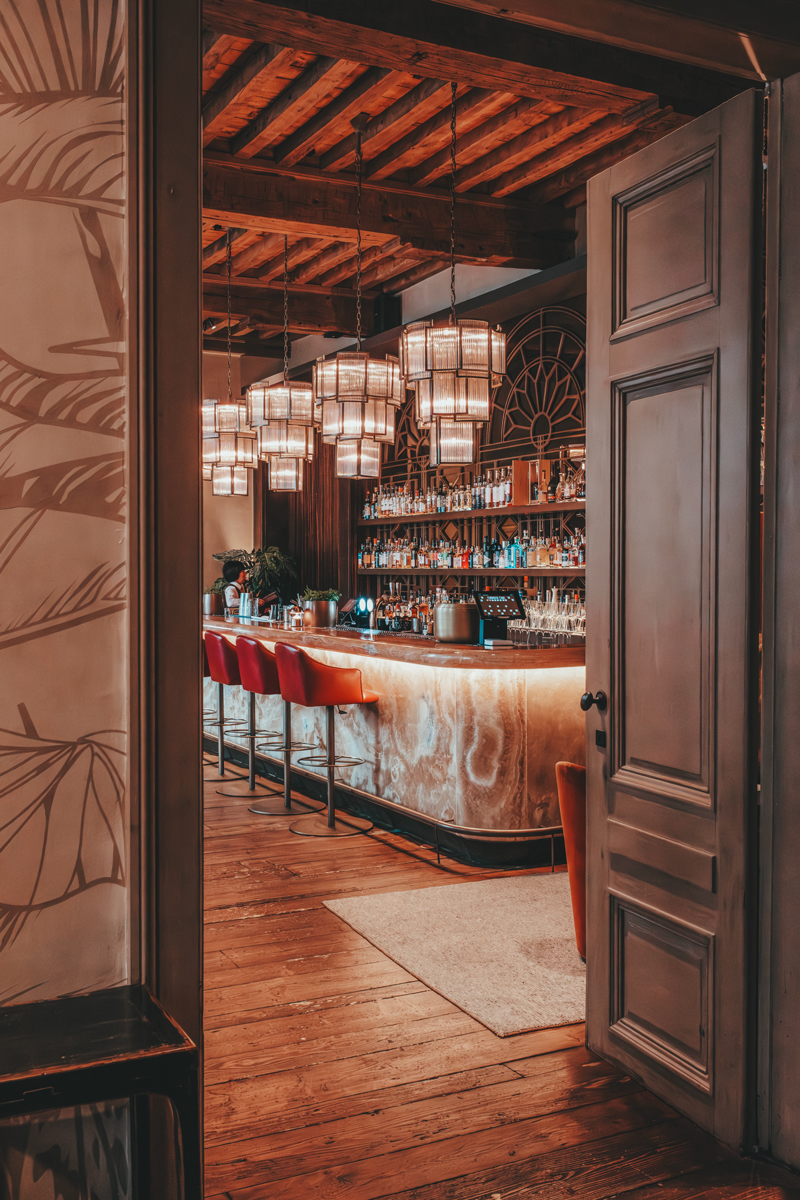 Bar viewed through ornate doorway at Botanic Sanctuary, Antwerp