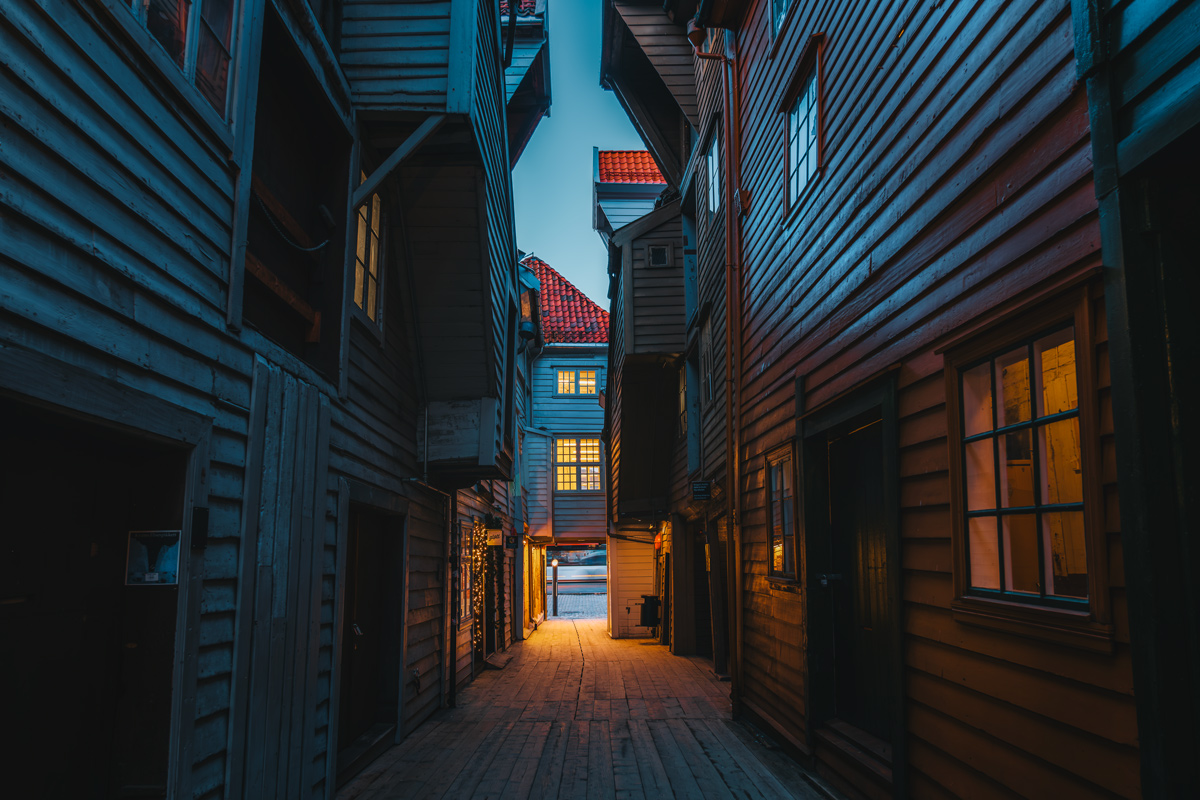 Wooden alley between Bryggen warehouses at blue hour, Bergen