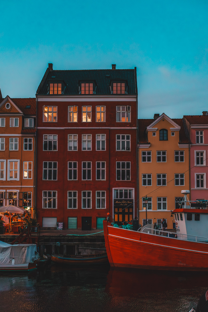 Nyhavn facades and red boat at dusk, Copenhagen